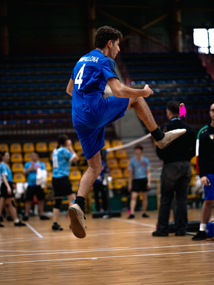 Shuttlecock rally in play with athletes exchanging over the net